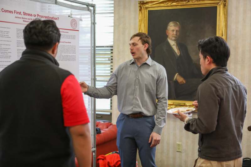 a man standing in front of a poster