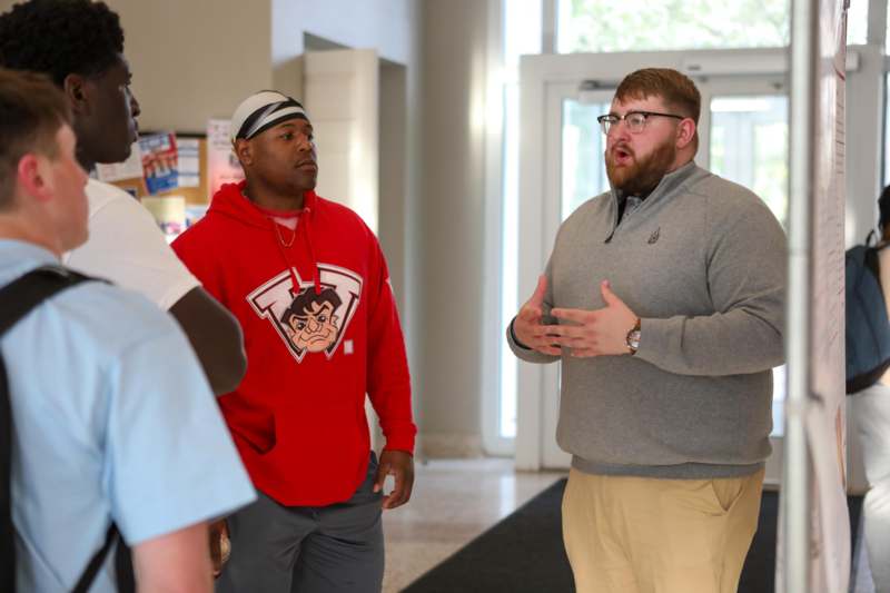 a group of men standing in a hallway