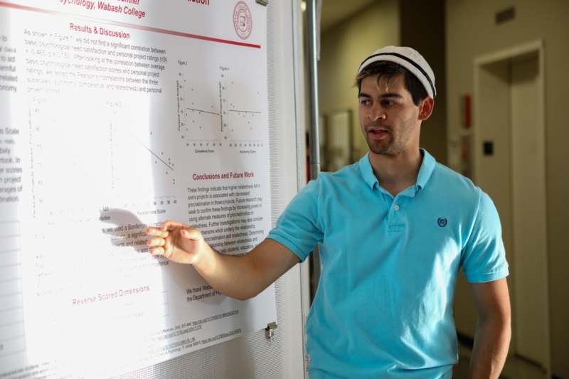 a man pointing at a white board