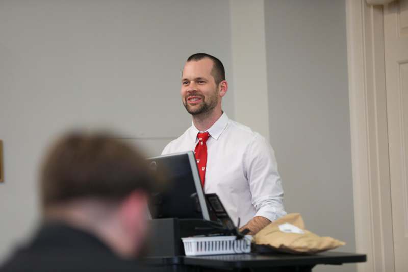 a man standing in front of a computer