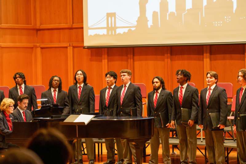 a group of men singing in a room