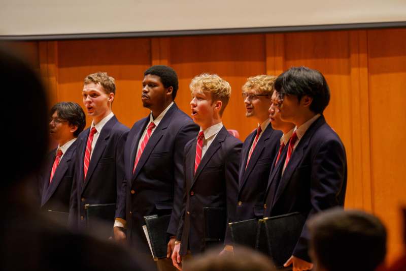 a group of men in suits singing
