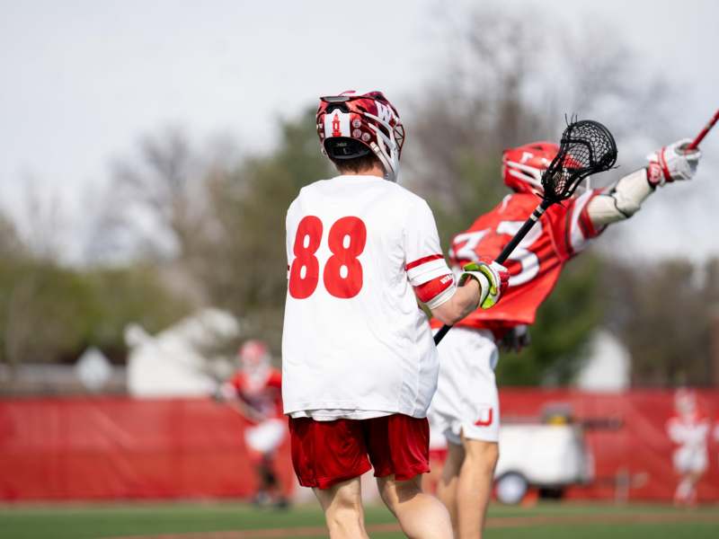 a group of people playing lacrosse