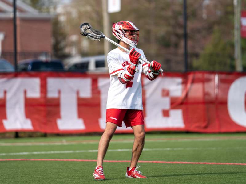 a man holding a lacrosse stick
