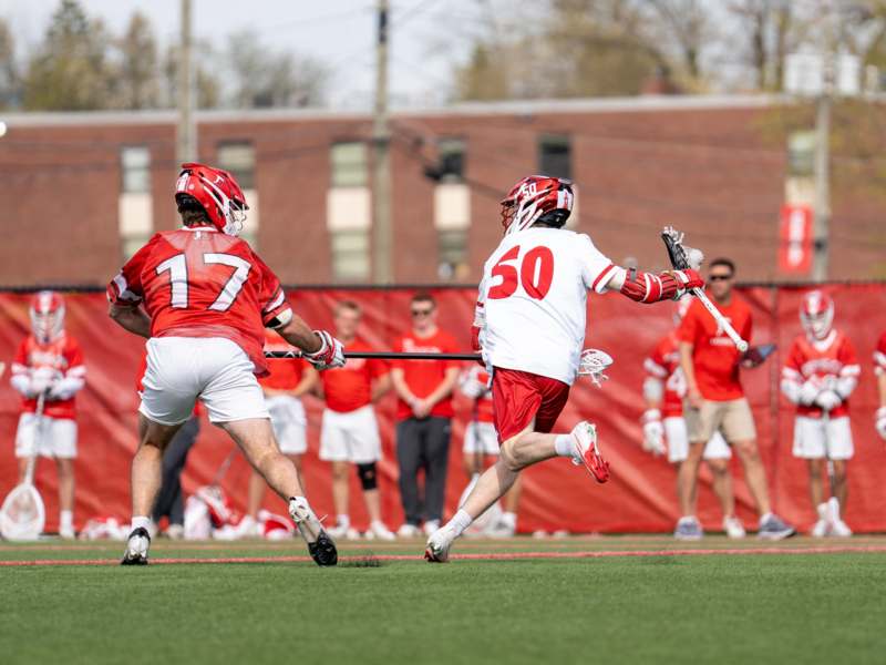 a group of men playing lacrosse