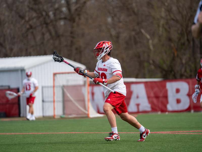 a man holding a lacrosse stick