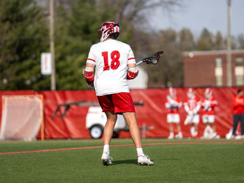a man holding a lacrosse stick