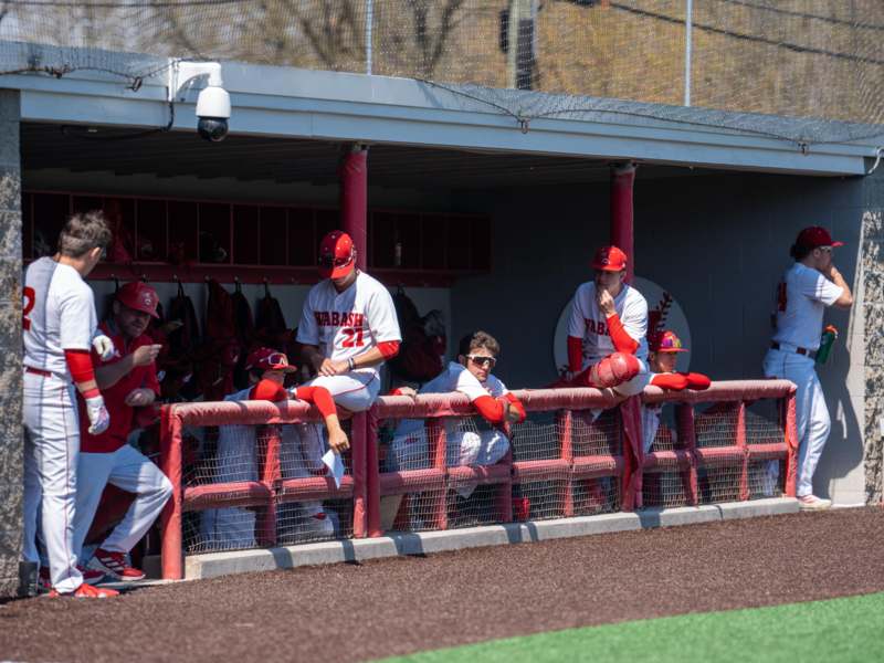 a group of people sitting on a fence
