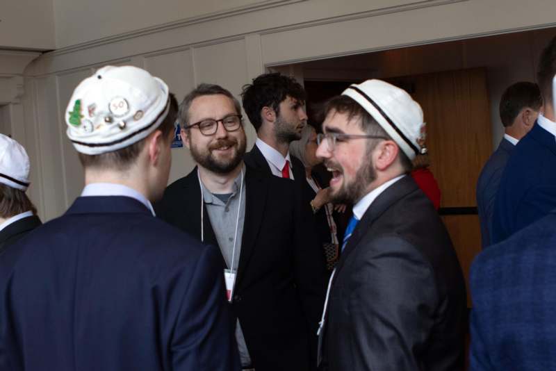 a group of men in suits and hats