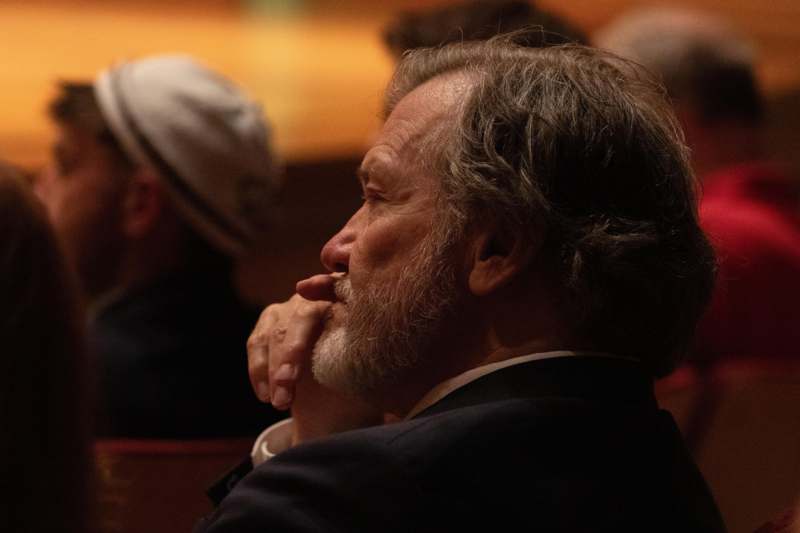 a man with his hand on his mouth