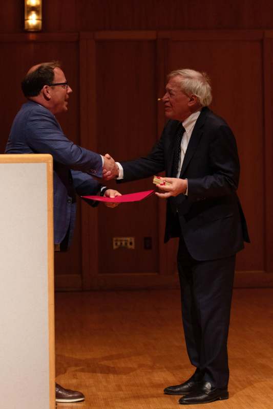 a man shaking hands with another man