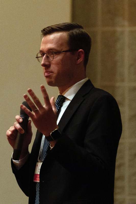 a man in a suit holding a microphone