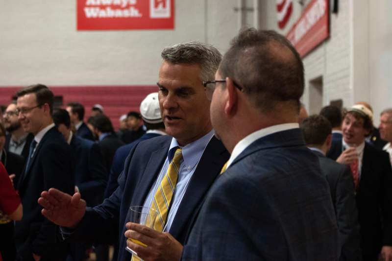 a group of men in suits talking