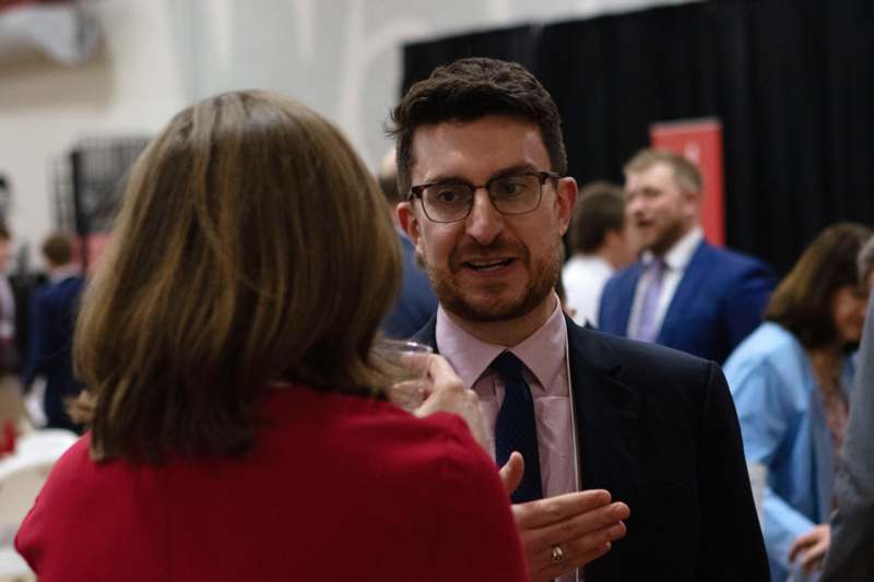 a man in a suit talking to a woman