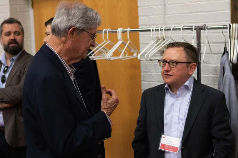 a group of men standing in front of swingers