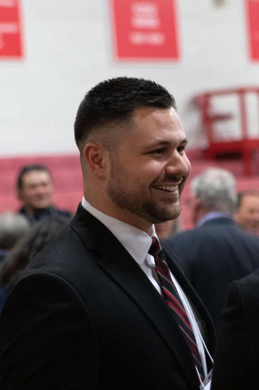 a man in a suit smiling