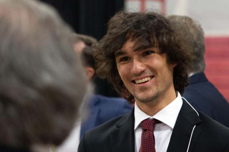 a man in a suit smiling