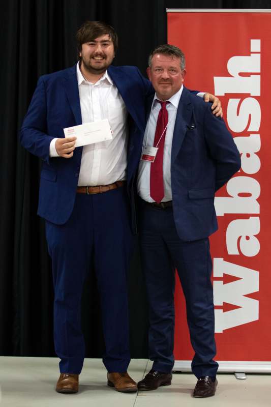 two men in suits standing together