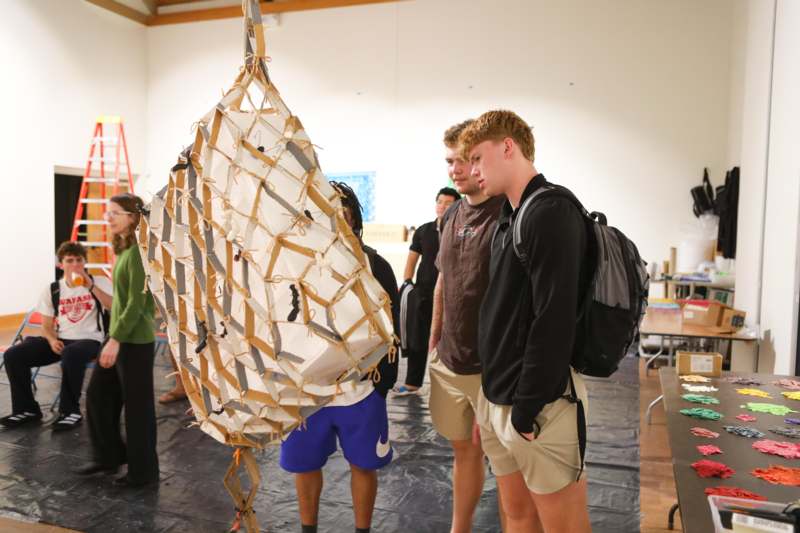 a group of people standing around a object
