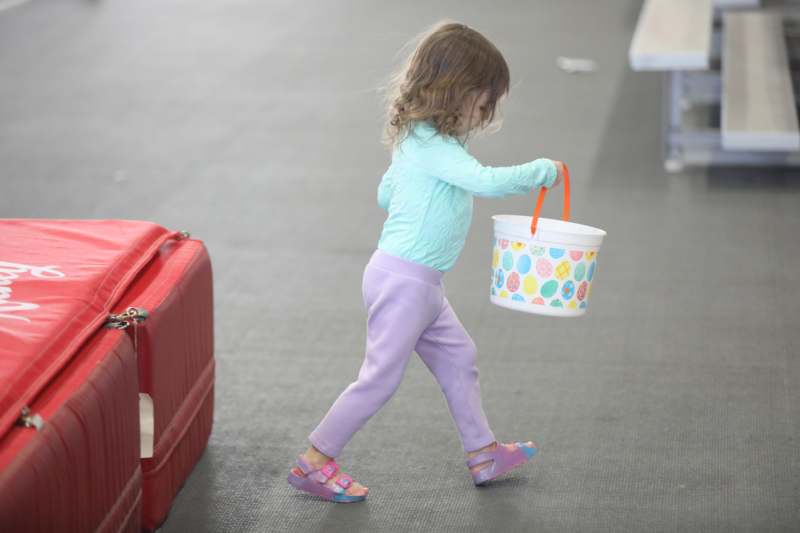 Athletic Leadership Academy Easter Egg Hunt - a child walking with a bucket