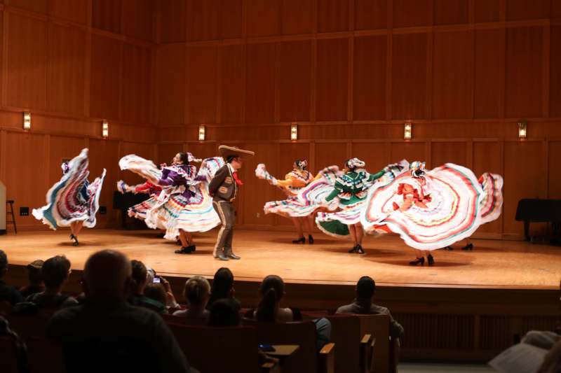 a group of people dancing on a stage