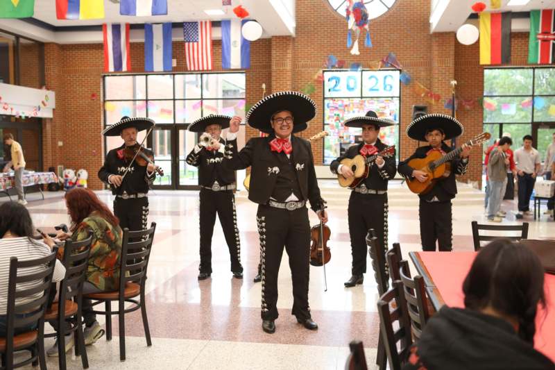 Culture Night - a group of people in mariachi clothing playing instruments