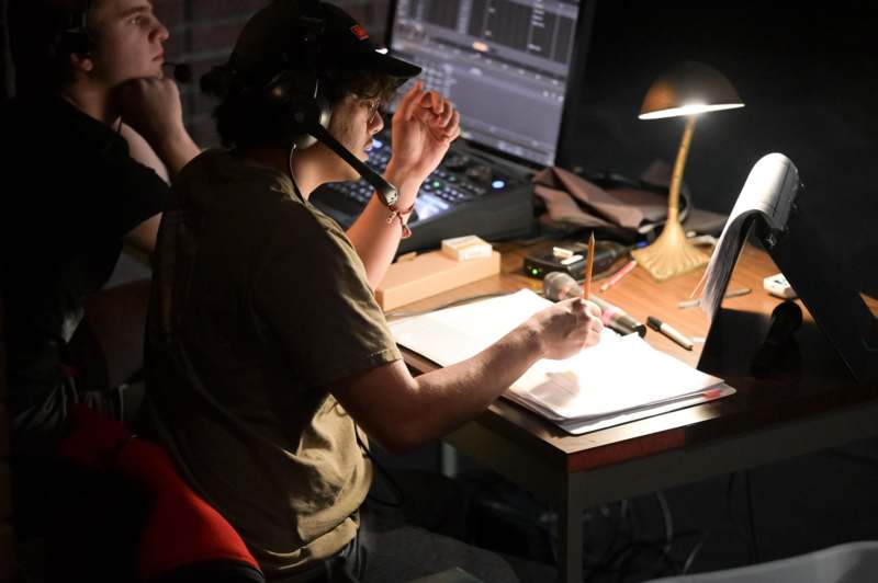 a man in a headset writing on a paper