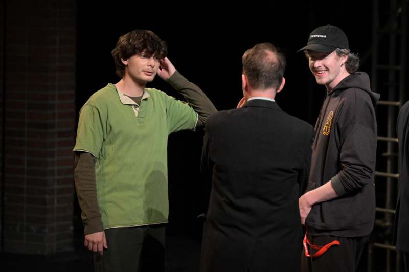 a group of men standing in front of a man