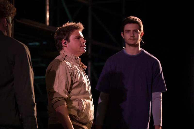 a group of men standing on a stage