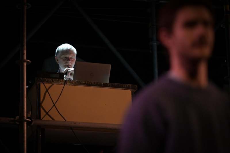 a man sitting at a desk with a laptop