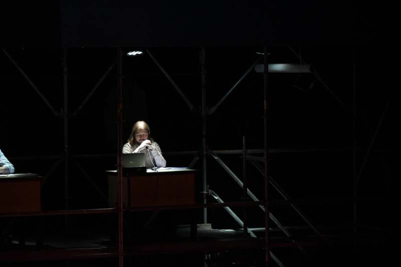 a man sitting at a desk with a laptop