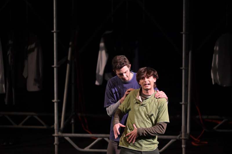 a man holding another man's stomach