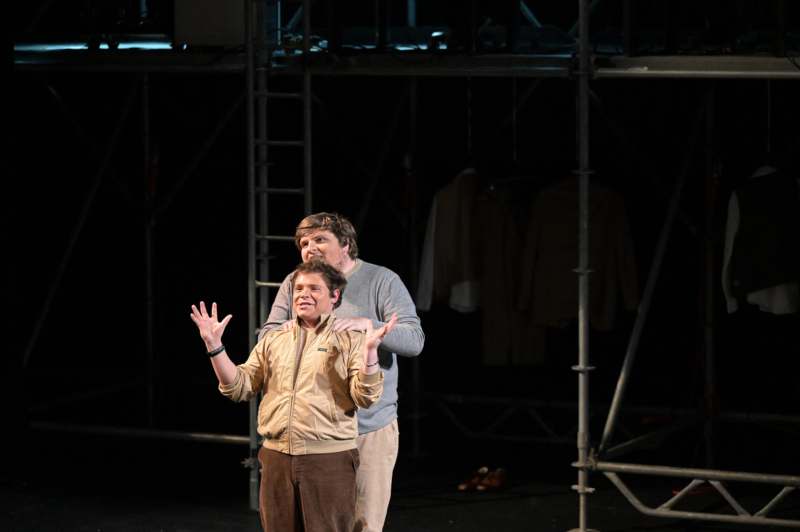 two men standing on a stage