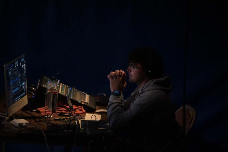 a man sitting at a desk with his hands clasped together