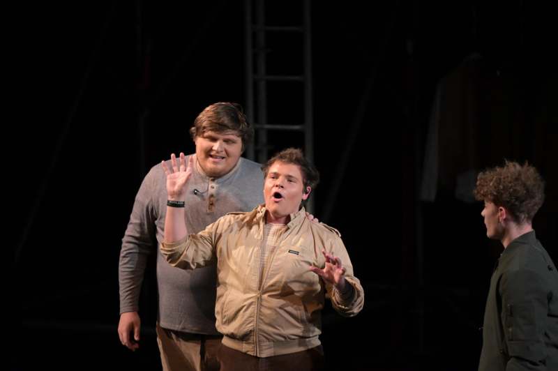 two men standing on a stage