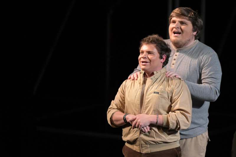 two men standing on a stage