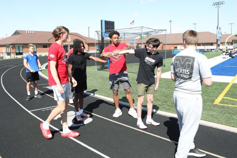 a group of people shaking hands on a track