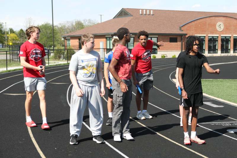a group of people standing on a track