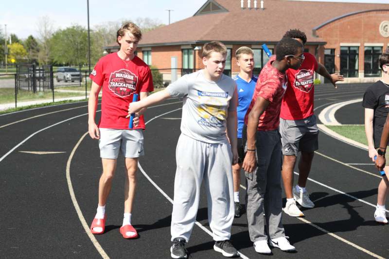 a group of men standing on a track