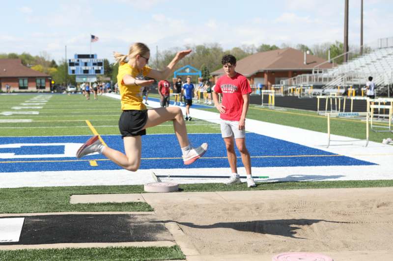 a woman jumping over a block