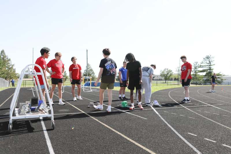 a group of people standing on a track