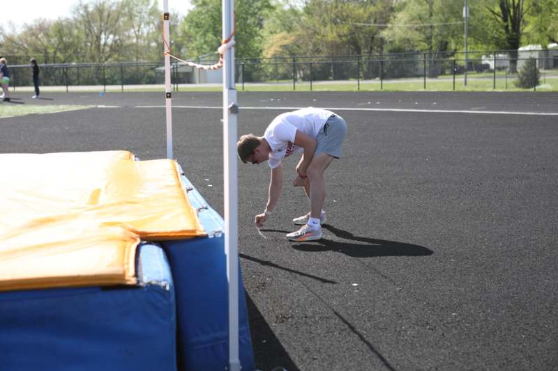a man bending over on a track