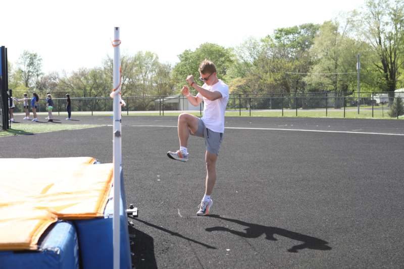 a man jumping on a pole