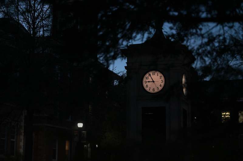 a clock tower with a white face