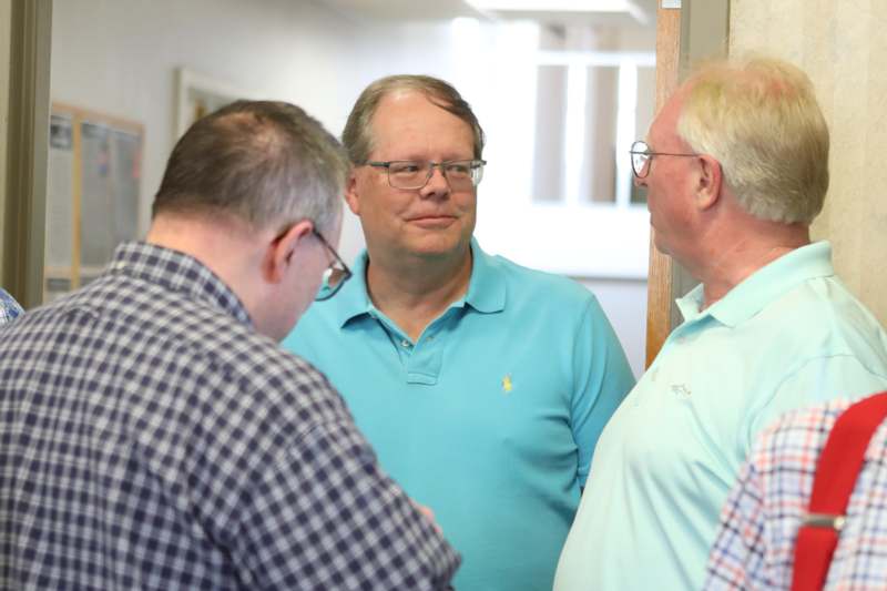 a group of men standing in a hallway