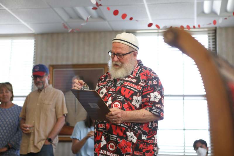 a man writing on a clipboard