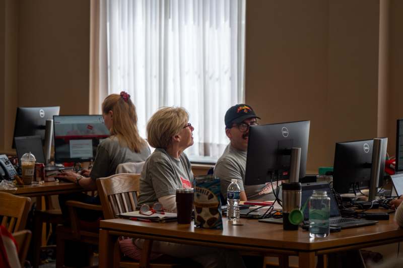 a group of people sitting at computers