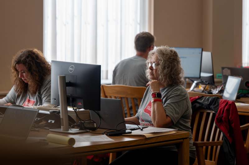 a woman sitting at a desk with a computer