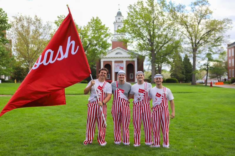 a group of people wearing matching outfits holding a flag