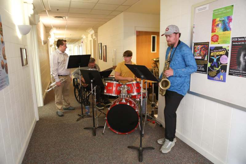a group of people playing instruments in a hallway